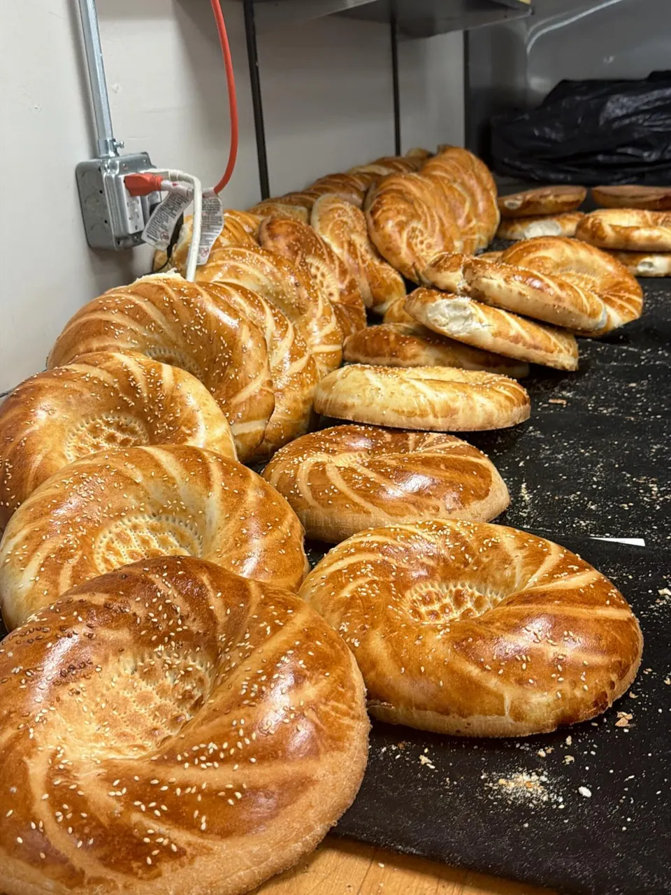 Round sesame breads on a bakery counter